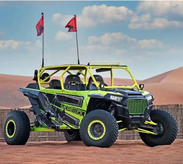 Yellow and black off-road dune buggy with roll cage and safety flags parked in the Dubai desert for a buggy tour