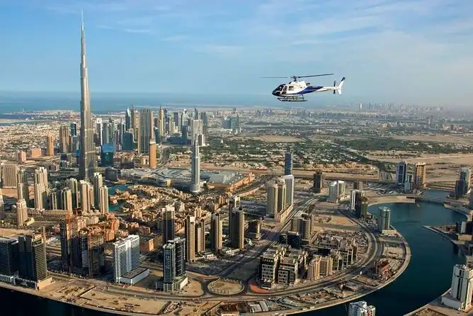 Helicopter flying over Downtown Dubai with an aerial view of Burj Khalifa and the city skyline below