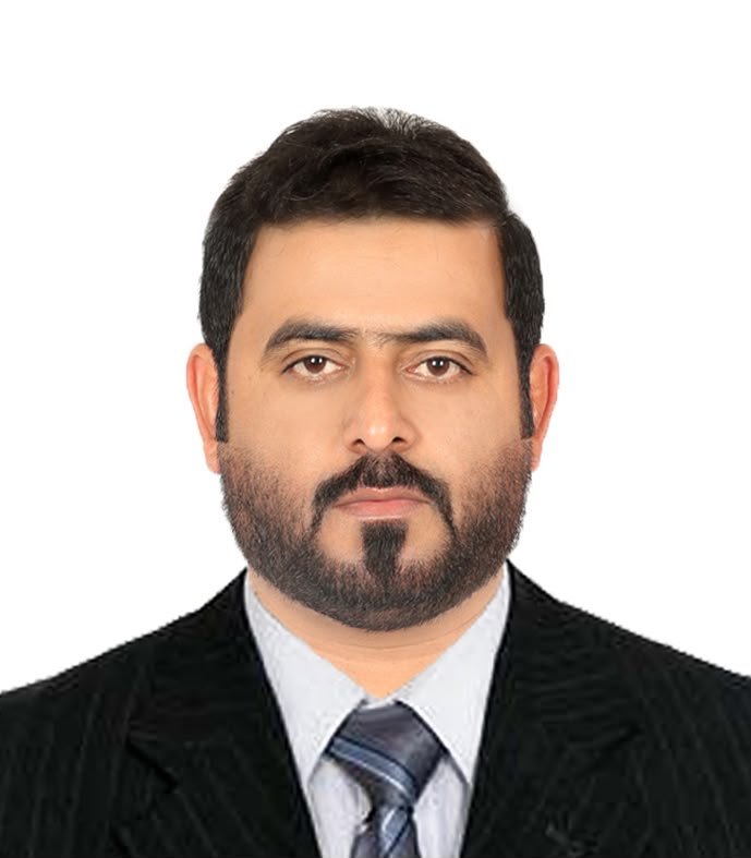 Khalifa Ali, owner of Wonder Star Tourism, professional headshot in a black suit and tie