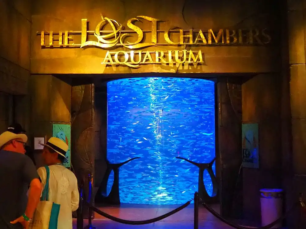 Entrance to The Lost Chambers Aquarium showing a large illuminated fish tank with visitors approaching